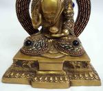 Statue de Bouddha assis adossé à une stèle incrustée de pierres semi-précieuses