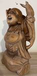 Petite statue de Bouddha rieur debout sur sac d'argent